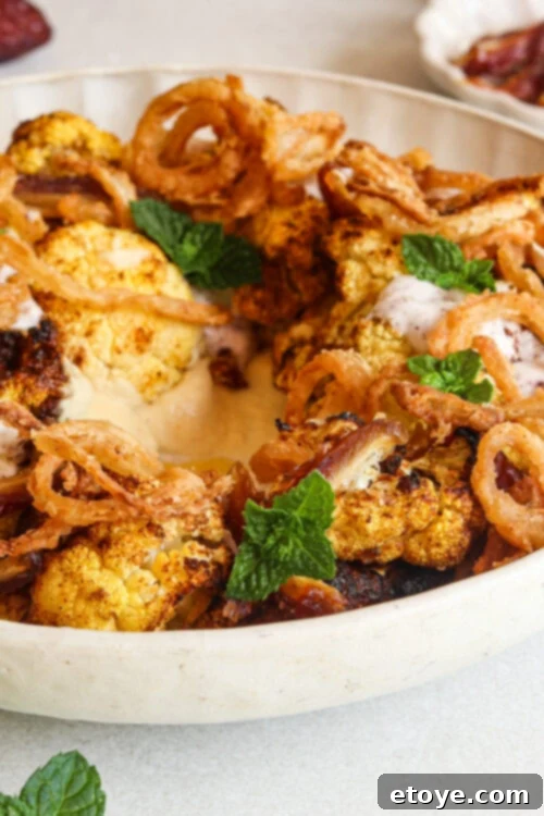 Moroccan Spiced Cauliflower Hummus Bowl with Coconut Yogurt Drizzle 3 Moroccan-spiced cauliflower salad with hummus, dates, and a coconut yogurt dressing