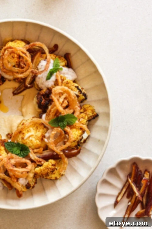 Moroccan Spiced Cauliflower Hummus Bowl with Coconut Yogurt Drizzle 4 Moroccan-spiced cauliflower salad with hummus, dates, and a coconut yogurt dressing