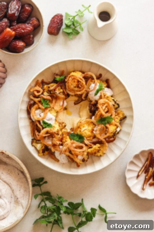 Moroccan Spiced Cauliflower Hummus Bowl with Coconut Yogurt Drizzle 5 Moroccan-spiced cauliflower salad with hummus, dates, and a coconut yogurt dressing