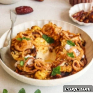 Moroccan Spiced Cauliflower Hummus Bowl with Coconut Yogurt Drizzle 7 Moroccan-spiced cauliflower salad with hummus, dates, and a coconut yogurt dressing