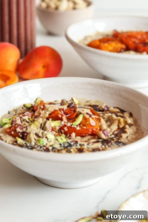 Adaptogen-Boosted Roasted Apricot Oatmeal 6 Roasted Apricot Adaptogenic Oatmeal with a spoon