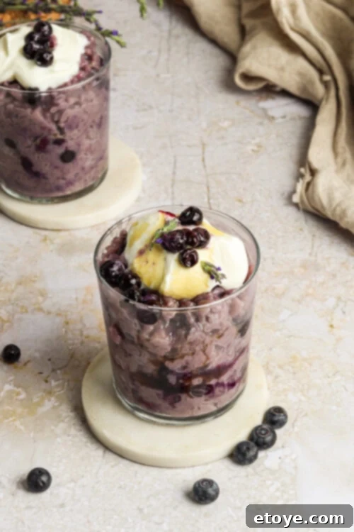 Final plated Blueberry Lavender Coconut Rice Pudding with garnishes, ready to eat