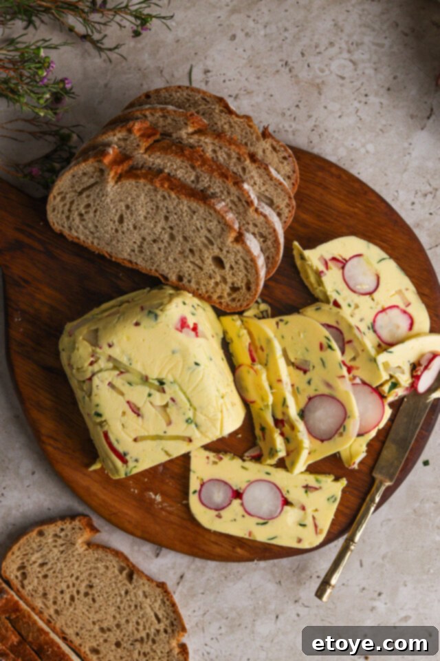 Radish and herb butter terrine on a wooden board