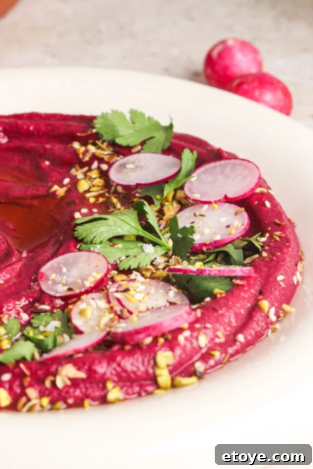 Crafting Purple Sweet Potato and Ginger Hummus 3 Close-up of Purple Sweet Potato Hummus, garnished with fresh herbs and spices