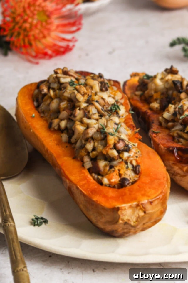 Fully assembled wild mushroom and sage stuffed butternut squash, ready to serve.