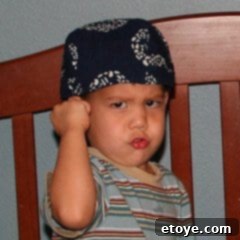 Another child's happy face, also eager for dinner