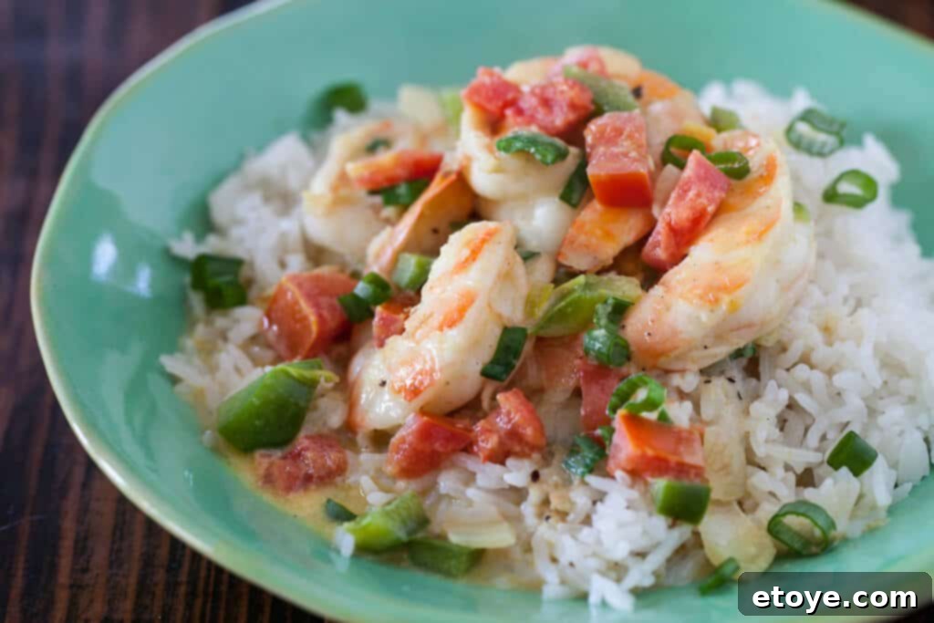 Close-up of succulent shrimp simmering in rich coconut curry sauce, promising a delightful meal