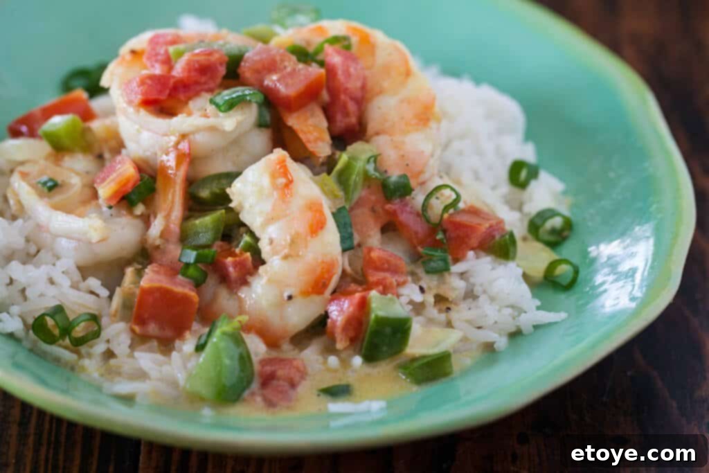 A close-up shot of the finished Coconut Curry Shrimp, garnished with fresh cilantro, ready to be served