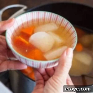 A bowl of delicious Chinese Daikon and Carrot Soup with pork and vegetables.