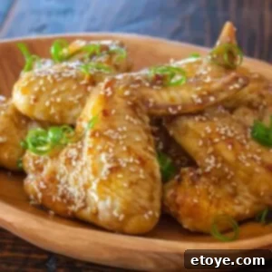 Sticky Asian Chicken Wings plated with garnishes