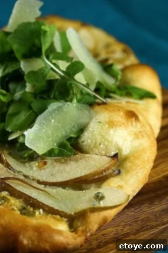 Gourmet Pear and Gorgonzola Flatbread Delicious Pear and Gorgonzola Flatbread with Baby Arugula and Shaved Parmesan