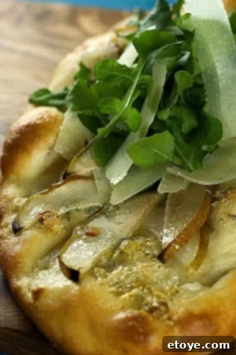 No Knead Pear Gorgonzola Flatbread Topped with Arugula and Parmesan 3 Pear and Gorgonzola Flatbread, Garnished and Ready to Serve