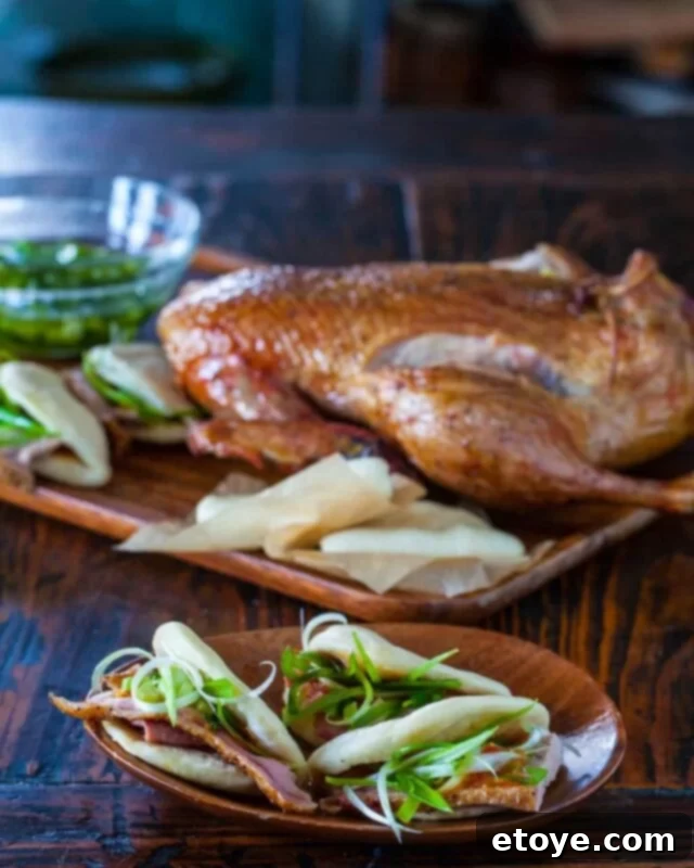 chinese roasted duck and steamed buns, perfectly cooked and arranged on a platter