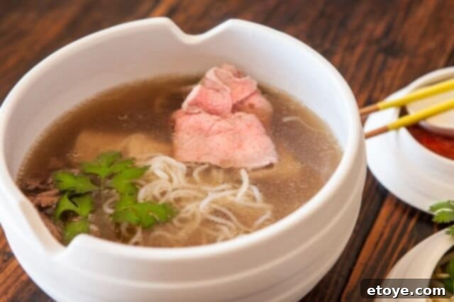 A beautifully presented bowl of Vietnamese Pho, ready to be enjoyed with fresh garnishes.