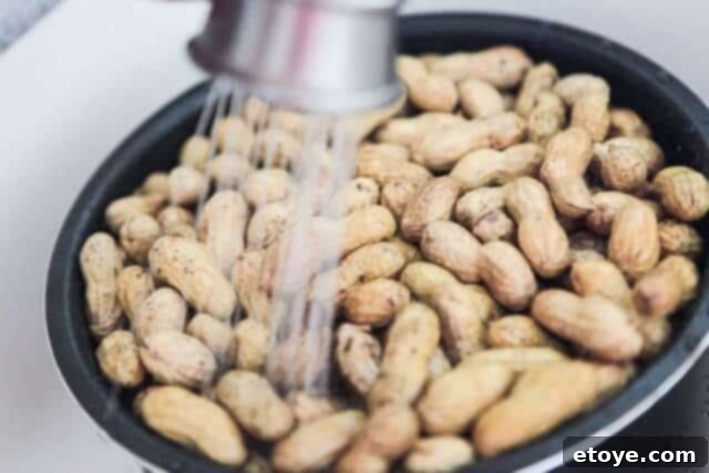 Classic Chinese Boiled Peanuts 3 Washing raw peanuts thoroughly under running water in a colander