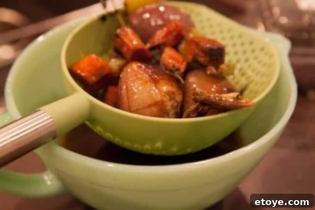 Prime Rib Roast Recipe - Straining Au Jus Straining au jus through a fine-mesh sieve