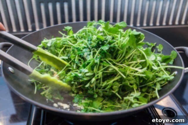 Garlic Stir-Fried Pea Shoots 5 Pea shoots wilting in the wok during stir-frying