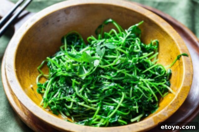 Garlic Stir-Fried Pea Shoots 9 Garnished Chinese stir-fried pea shoots ready to be served