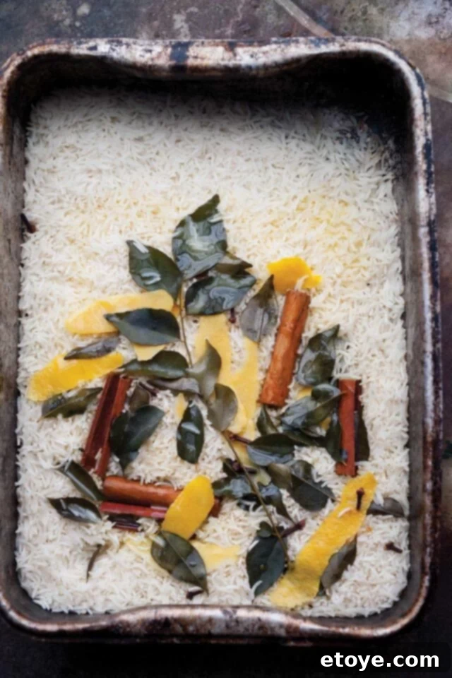 Aromatic Basmati with Lemon, Cinnamon and Curry Leaf 2 A beautifully presented dish of Lemon, Cinnamon, and Curry Leaf Basmati Rice, garnished with fresh curry leaves and lemon wedges.