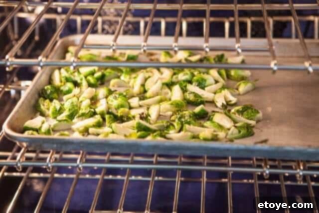 Sweet and Savory Brussels Sprouts with Lap Cheong 8 Brussels sprouts roasting in the oven, achieving perfect tenderness and caramelization.