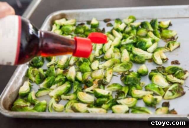 Sweet and Savory Brussels Sprouts with Lap Cheong 9 Roasted Brussels sprouts being drizzled with fish sauce, adding a layer of umami.