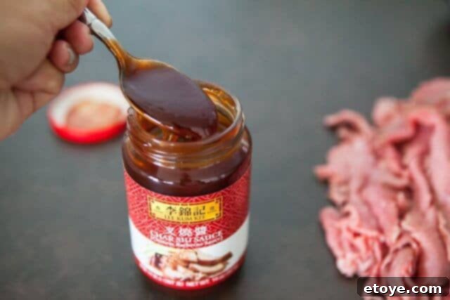 Excalibur Dehydrator Review and Giveaway 8 Marinated beef slices being placed on dehydrator trays.