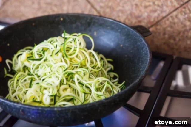 Korean Zucchini Noodle Recipe - Stir Fry Zucchini Stir-Frying Zucchini Noodles in a Wok