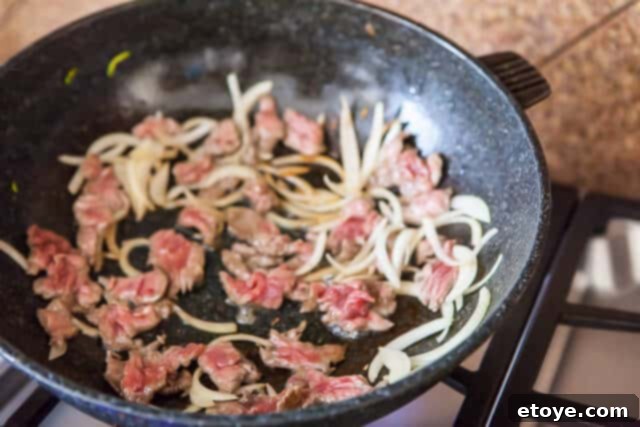 Korean Zucchini Noodle Recipe - Stir Fry Meat Onion Stir-Frying Marinated Beef and Onion in Pan