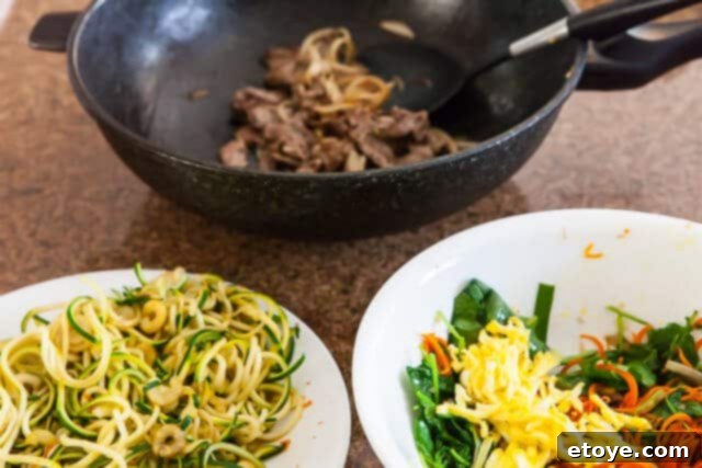 Korean Zucchini Noodle Recipe - Toss to Combine Tossing All Ingredients for Korean Zucchini Noodles