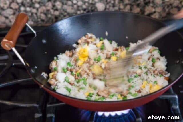 Tossing Ingredients Together chicken fried rice recipe - add peas