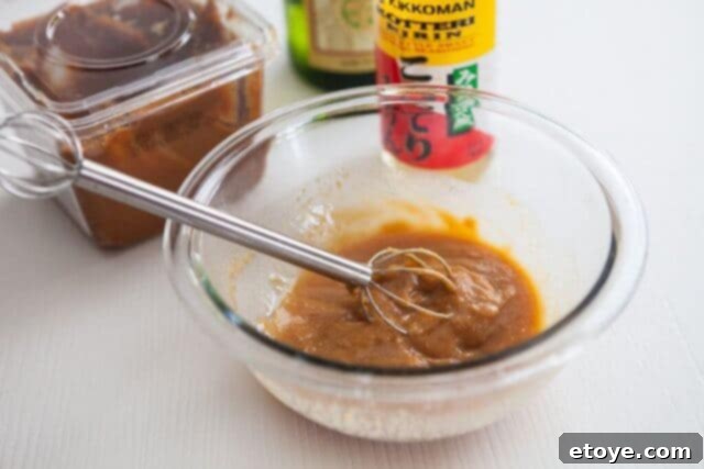 Miso paste in a bowl, showing its thick and creamy texture.