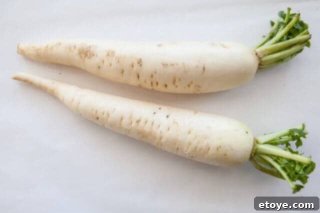 Fresh daikon radish, peeled and cut into large chunks, ready for use in Chinese Daikon Soup.