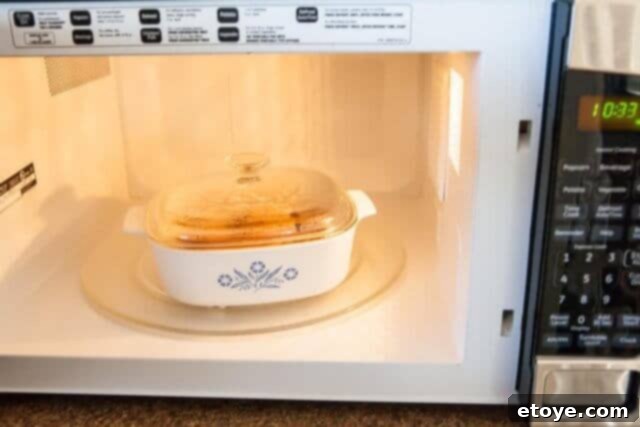 Covered bowl microwaving seasoning liquids for roasted peanuts.