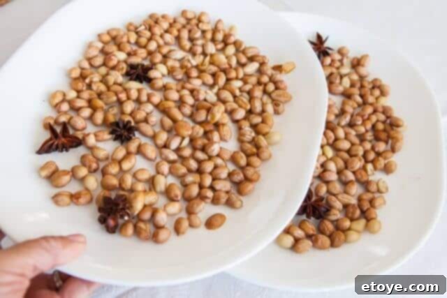 Dividing peanuts into two batches on separate plates for microwave roasting.