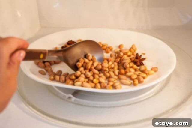 Final stir of peanuts before the last microwave increment.