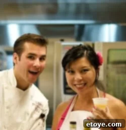 Blogger enjoying the chef's company during a fun culinary event