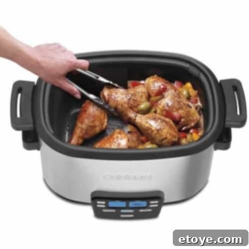The Cuisinart Multi Cooker in operation, showcasing its nonstick pot and clear lid.