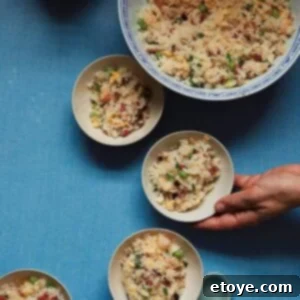 Perfect Yangzhou Fried Rice 3 A close-up shot of a beautifully presented bowl of Yangzhou Fried Rice, with visible grains, shrimp, and vegetables.