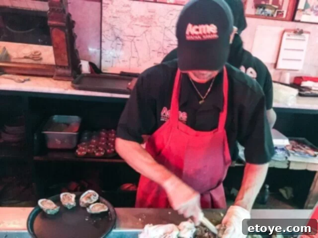 Raw oysters on the half shell at Acme Oyster House, a classic New Orleans dining experience at the bustling oyster bar.