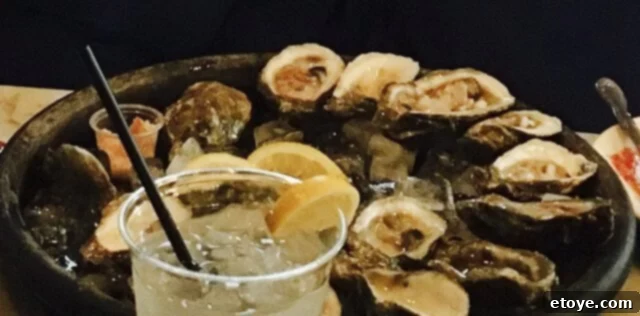 Classic char-grilled and raw oysters served at Royal Oyster House in New Orleans, maintaining a rich culinary tradition.
