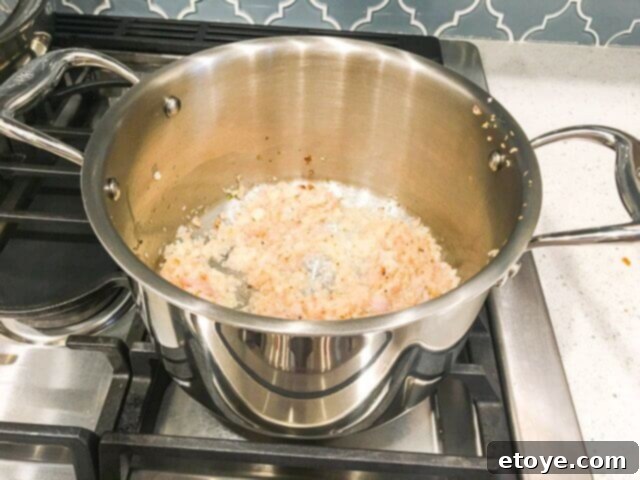 Hammer Stahl Slow Cooker Review Delicious Meals and a Chance to Win 11 Garlic and shallots browning in the Hammer Stahl stockpot on a stovetop.