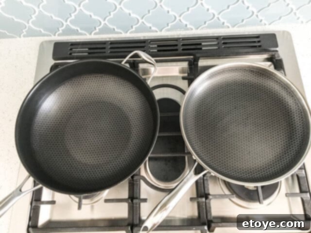 HexClad Fry Pan Review And Giveaway 4 Side-by-side comparison of a Black Cube Wok on the left and the HexClad 12-inch frying pan on the right, showcasing their similar hybrid designs.