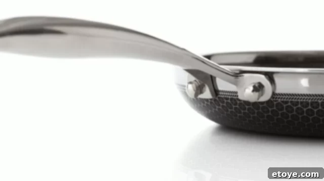 HexClad Fry Pan Review And Giveaway 7 Close-up view of the HexClad pan's stay-cool handle, showcasing its design and attachment to the pan.