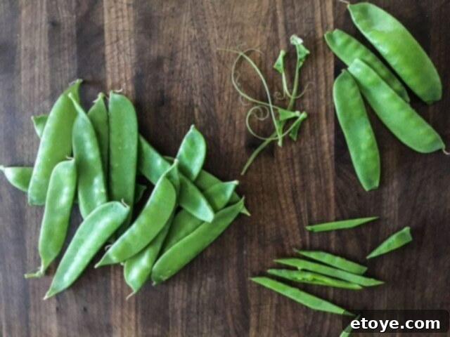 Fresh snow peas, diagonally sliced into long strips, ready for a quick stir-fry.
