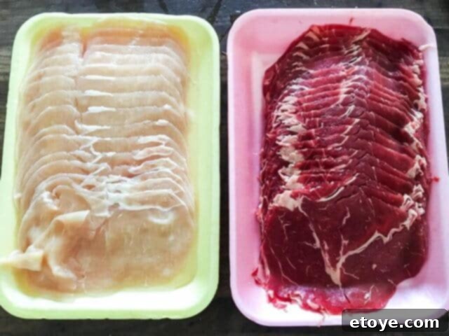 Assortment of thinly sliced meats, perfect for quick cooking in Mongolian BBQ or hot pot.