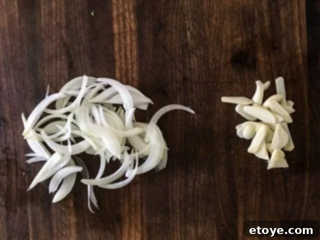Thinly sliced onions, prepped for quick stir-frying to release their aromatic flavors.