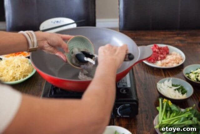 Cooking oil shimmering in a hot wok, ready for the first stir-fry ingredients.
