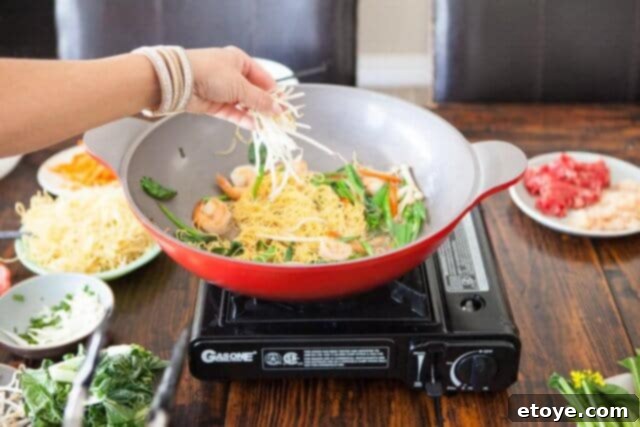 Fresh bean sprouts and roasted sesame seeds added to the nearly finished stir-fry for a final touch.