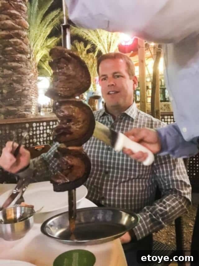 Happy husband enjoying Picanha at Fogo de Chão