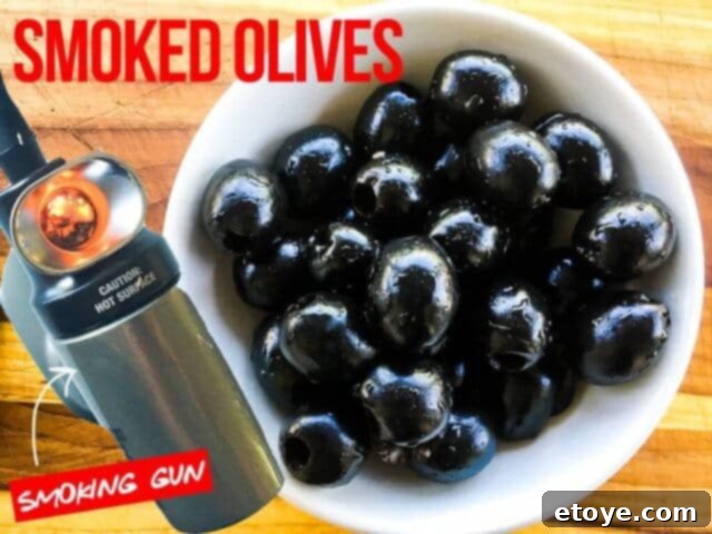 Delicious Smoked Olives Using a Smoking Gun 2 A close-up shot of a bowl of plump, glistening California ripe olives, invitingly arranged.